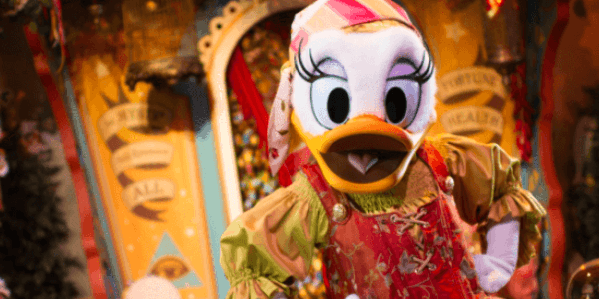 Daisy Duck in a magician outfit with her hands on her hips.
