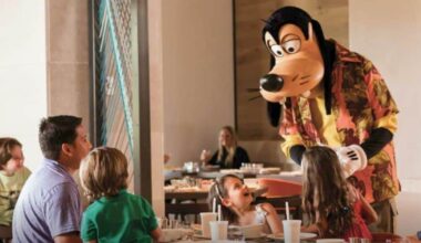 Goofy welcomes a happy family at their table during character dining, creating magical moments at a Disney park restaurant. Four Seasons Orlando Walt Disney World ownership change