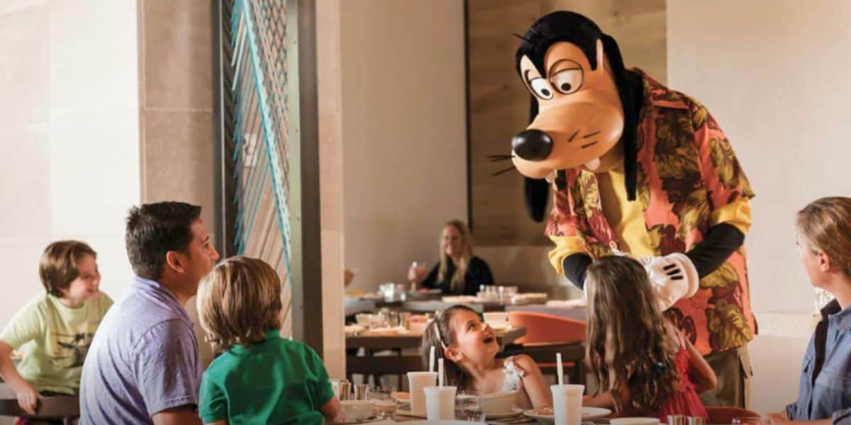 Goofy welcomes a happy family at their table during character dining, creating magical moments at a Disney park restaurant. Four Seasons Orlando Walt Disney World ownership change
