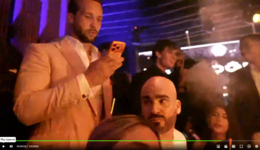 A bald man with a beard is seen on a live stream.