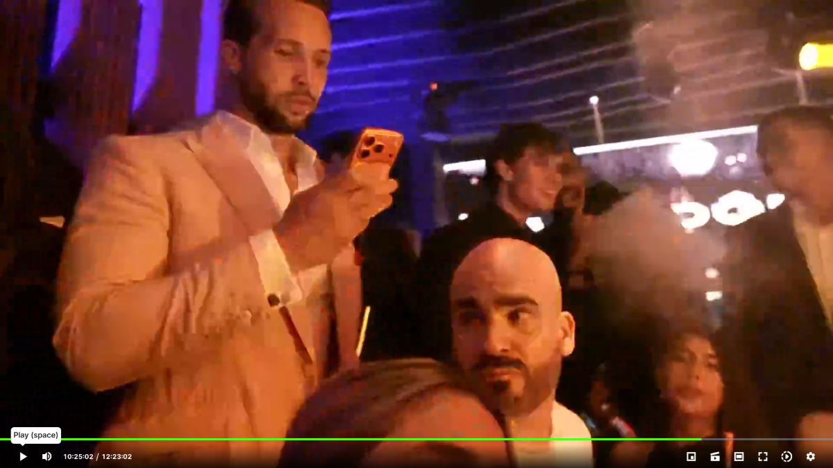 A bald man with a beard is seen on a live stream.