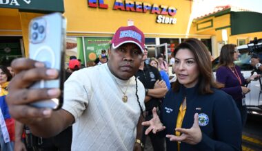 photo of a man posing for a selfie with Doral mayor Christi Fraga in front of a business named, "El Arepazo Store"
