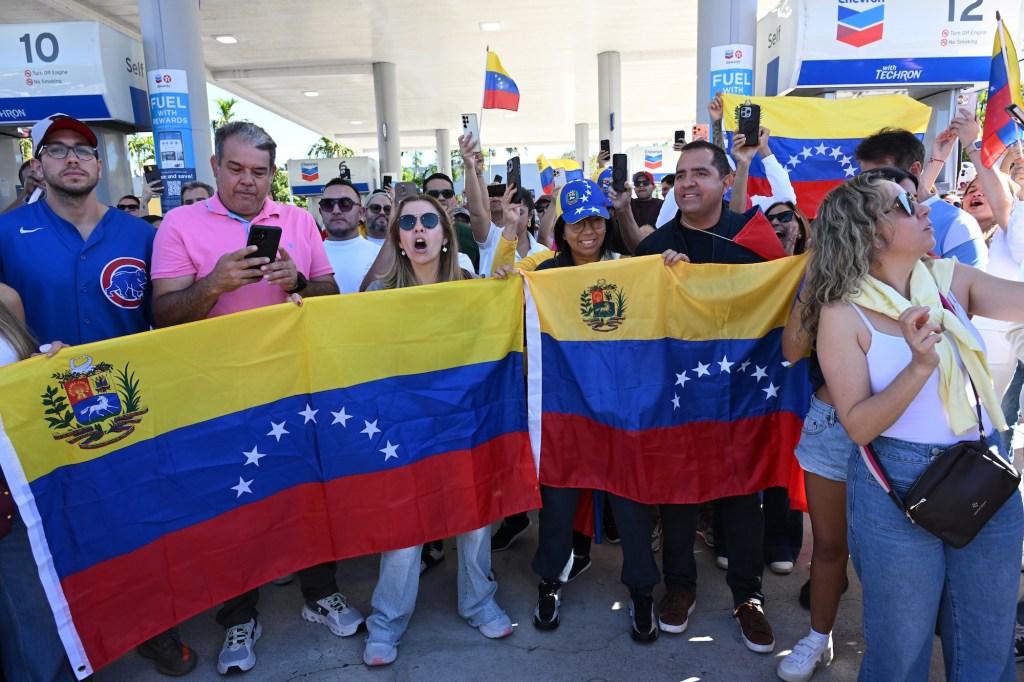 photo of protesters wearing clothes with the Venezuelan flag and waving Venezuelan flags.
