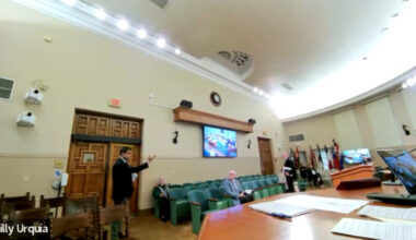 Vince Lago pointing towards the commission as he stands by the door to exit the commission chambers.