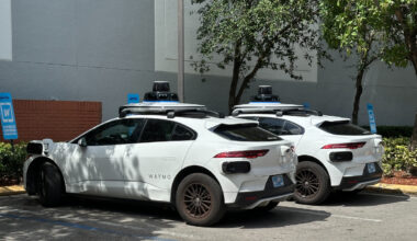 Two white sedans parked next to each other.