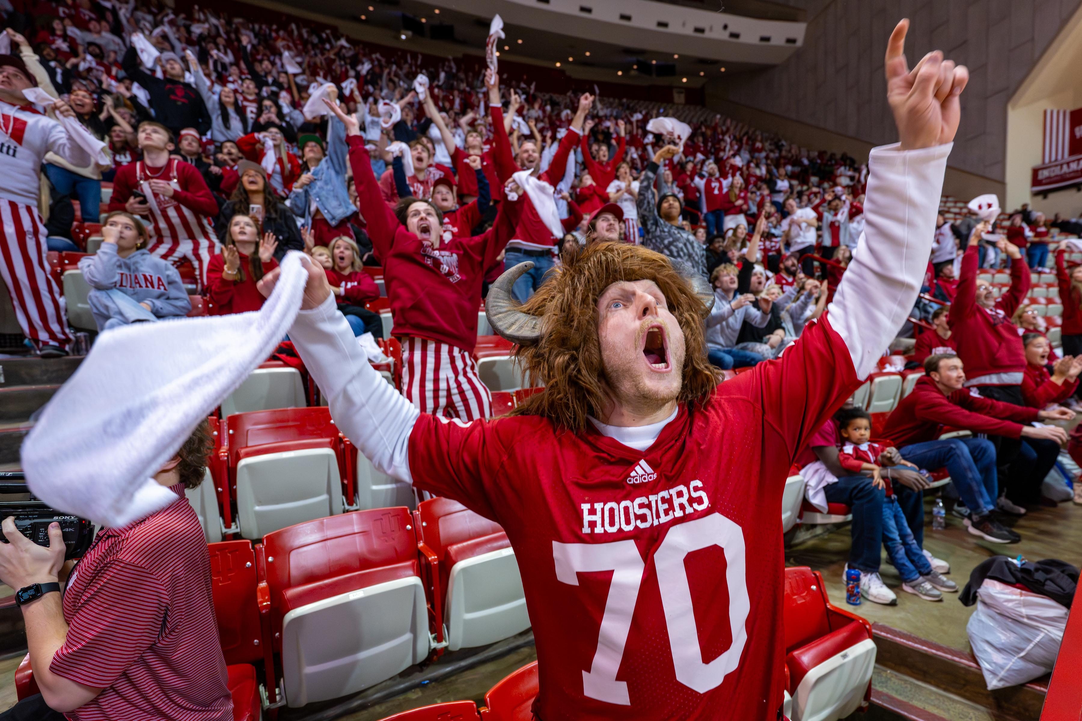 Andrew Bailey, of Carmel, Ind., foreground, reacts with other fans inside Indiana University's Assembly Hall in Bloomington, Ind., after Indiana scored a touchdown during the NCAA College Football Playoff National Championship game against Miami in Miami Gardens, Fla., Monday, Jan. 19, 2026. (AP Photo/Doug McSchooler)