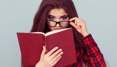 Young woman with glasses reading a book, student