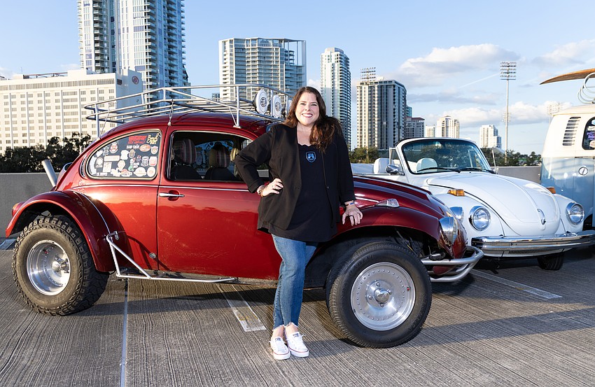 Ginger Galloway, founder of Pinstripe Marketing & Interactive, poses in her 1973 Volkswagen Baja Beetle named Rogue.