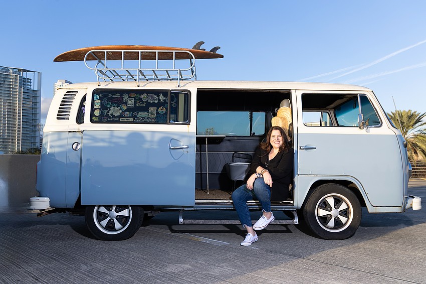 Ginger Galloway, founder of Pinstripe Marketing & Interactive, poses in her 1977 Volkswagen bus named Piper.