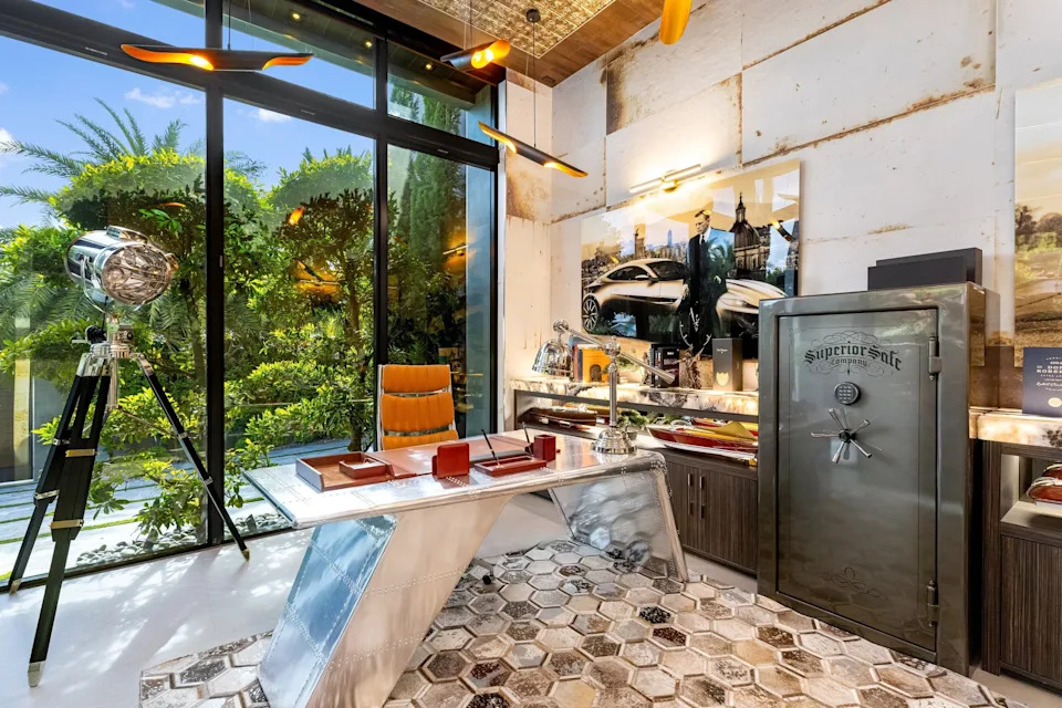 Office with rusted walls and a safe in celebrity developer Aldo Stars home in Florida