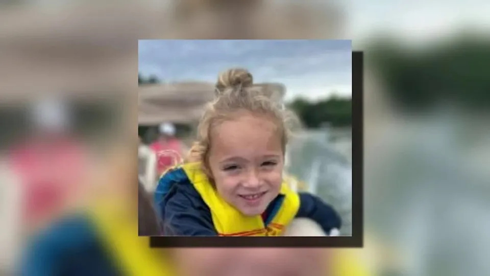 Johnathan Boley smiling in an undate photo, wearing a yellow life vest.