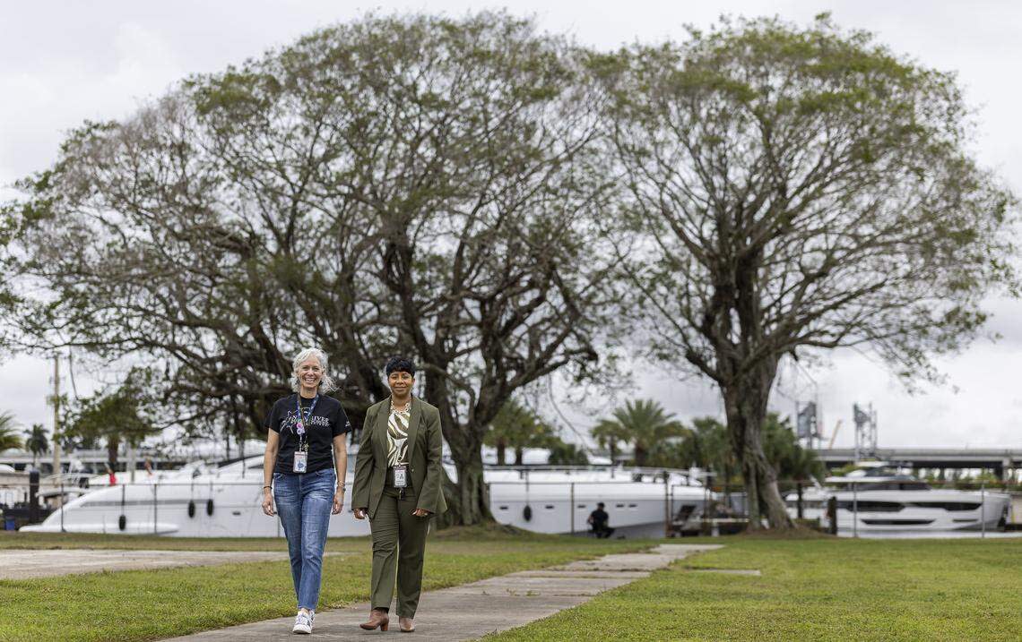 Elizabeth Fahy, the magnet coordinator and a marine science teacher, left, and Lezondra Harris, school principal, walk on the area where a potential new living shoreline may be built at New River Middle School.