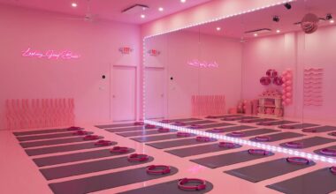 a studio lit in pink lighting with mats on the floor