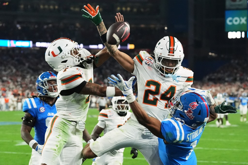 Miami defensive backs Zechariah Poyser and Ethan O'Connor break up a pass intended for Mississippi wide receiver De'zhaun Stribling during the Fiesta Bowl.