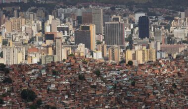 The downtown skyline rises behind the Cota 905 neighborhood in Caracas, Venezuela Sunday, Jan. 11, 2026. (AP/Matias Delacroix)