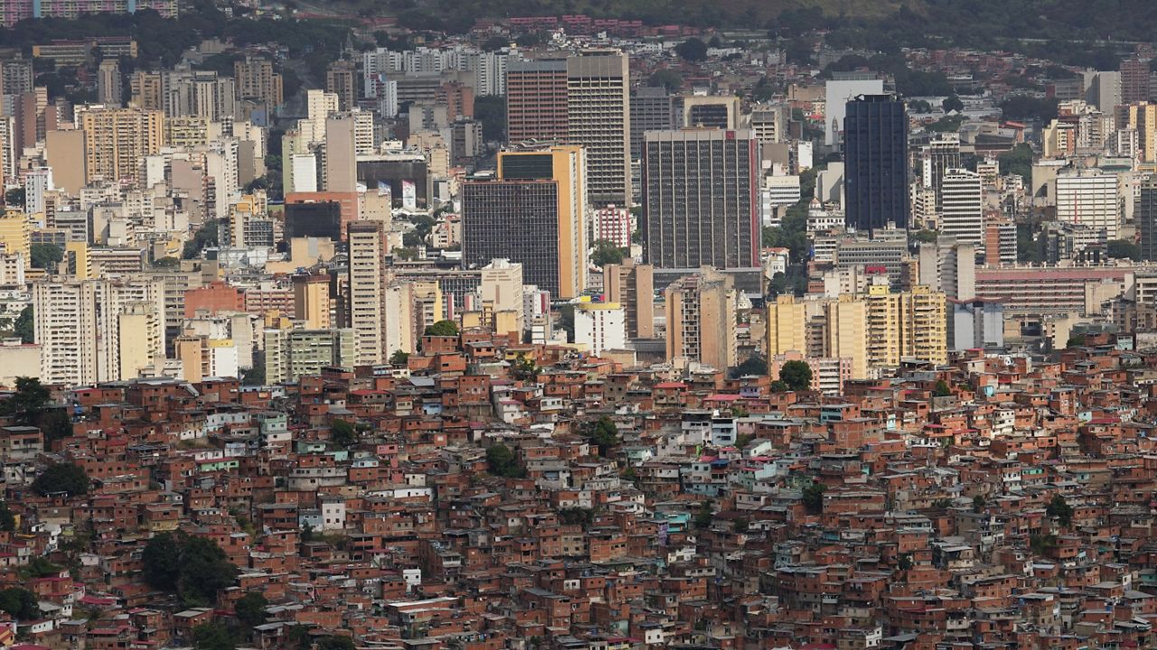 The downtown skyline rises behind the Cota 905 neighborhood in Caracas, Venezuela Sunday, Jan. 11, 2026. (AP/Matias Delacroix)
