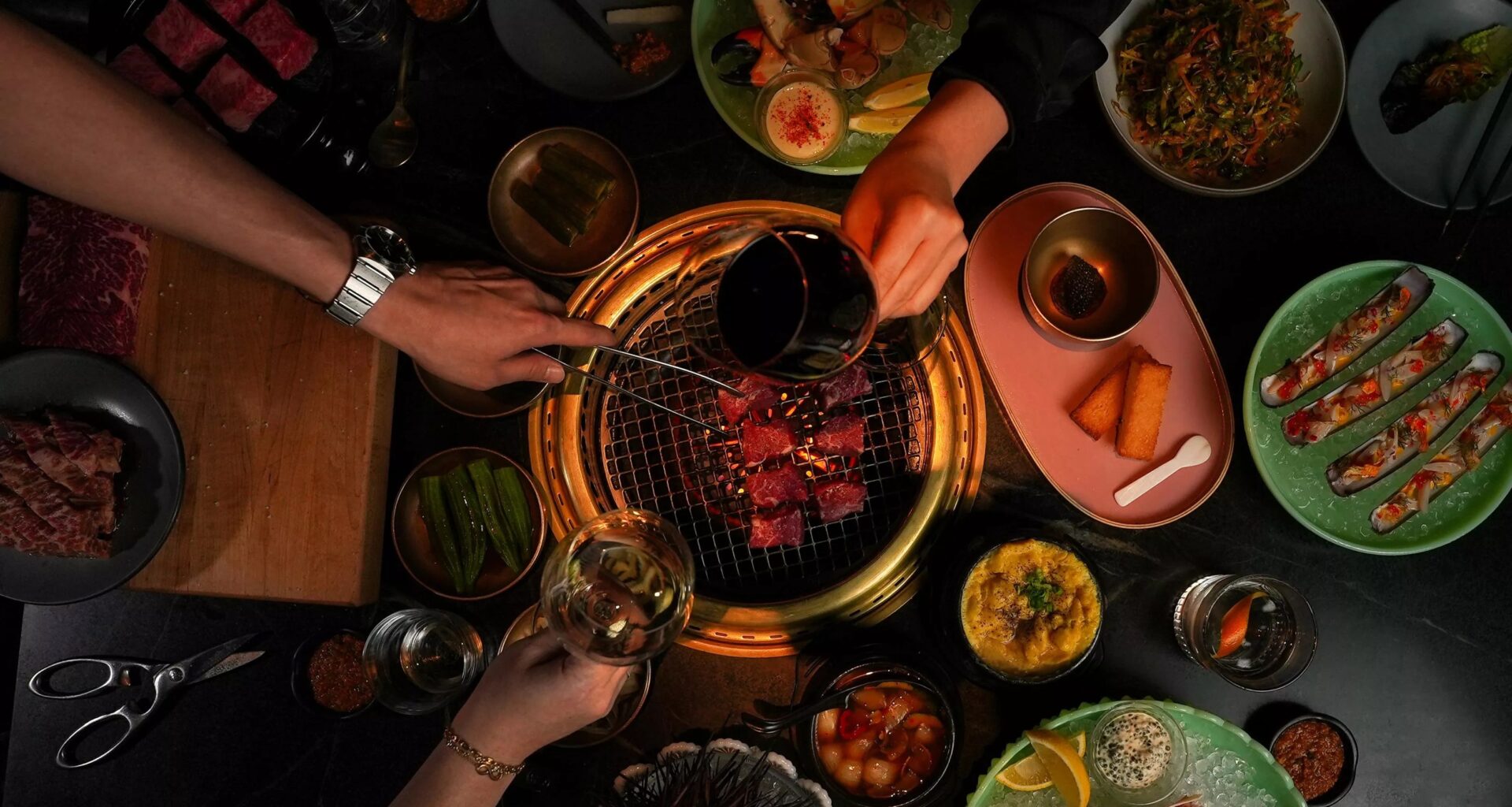 hands and food at Cote, one of the best places to eat in the U.S.