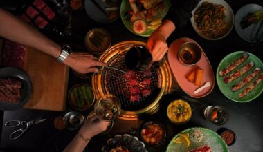 hands and food at Cote, one of the best places to eat in the U.S.