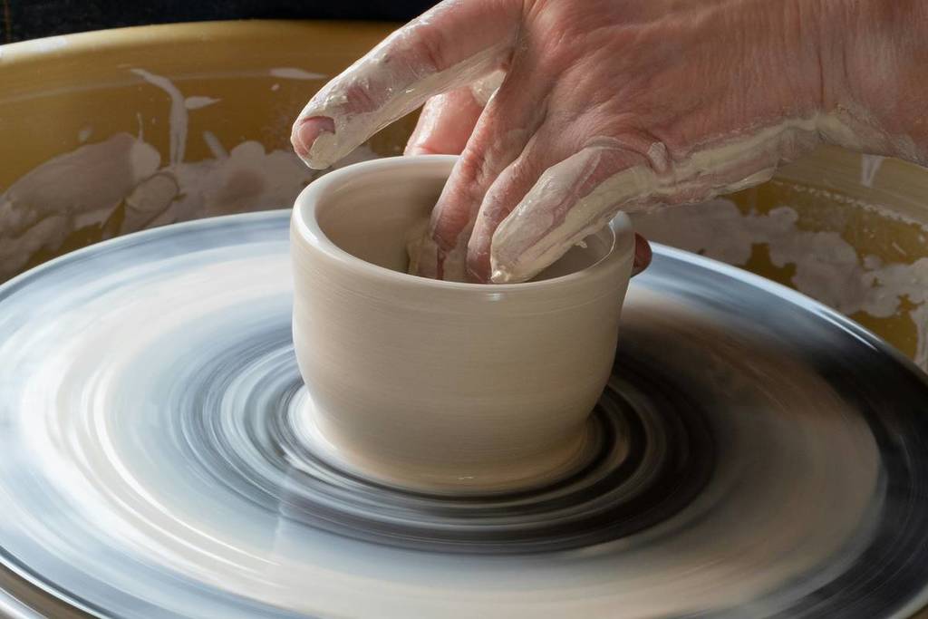 Creating cups on a potter's wheel