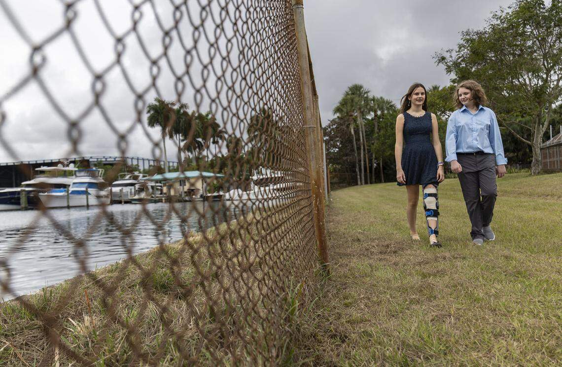 Students Eleonora Mariani, 13, left, and Nate Buck, 12, walk on the area where a potential new living shoreline may be built.