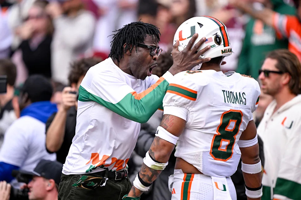Michael Irvin (left) celebrates with Miami defensive back Jakobe Thomas (8) during the team's College Football Playoff game against Texas A&M at Kyle Field.