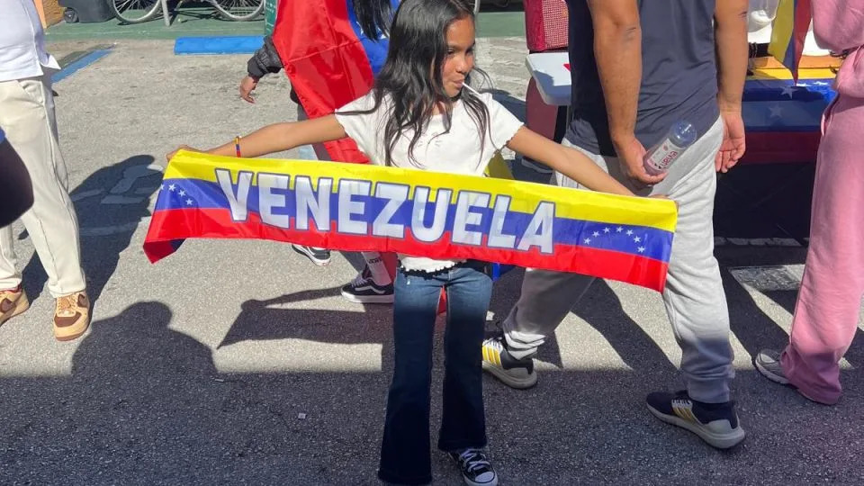 A little girl holds a Venezuela flag during celebrations in Doral, Florida, Saturday after Venezuela president's capture - CNN