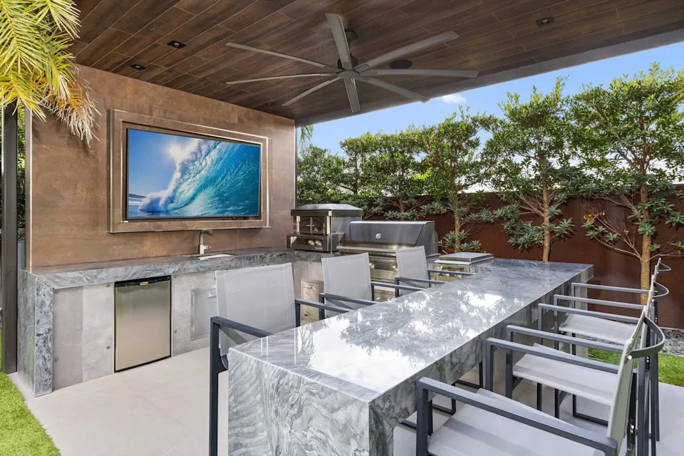 Outdoor kitchen in celebrity developer Aldo Stars home in Florida
