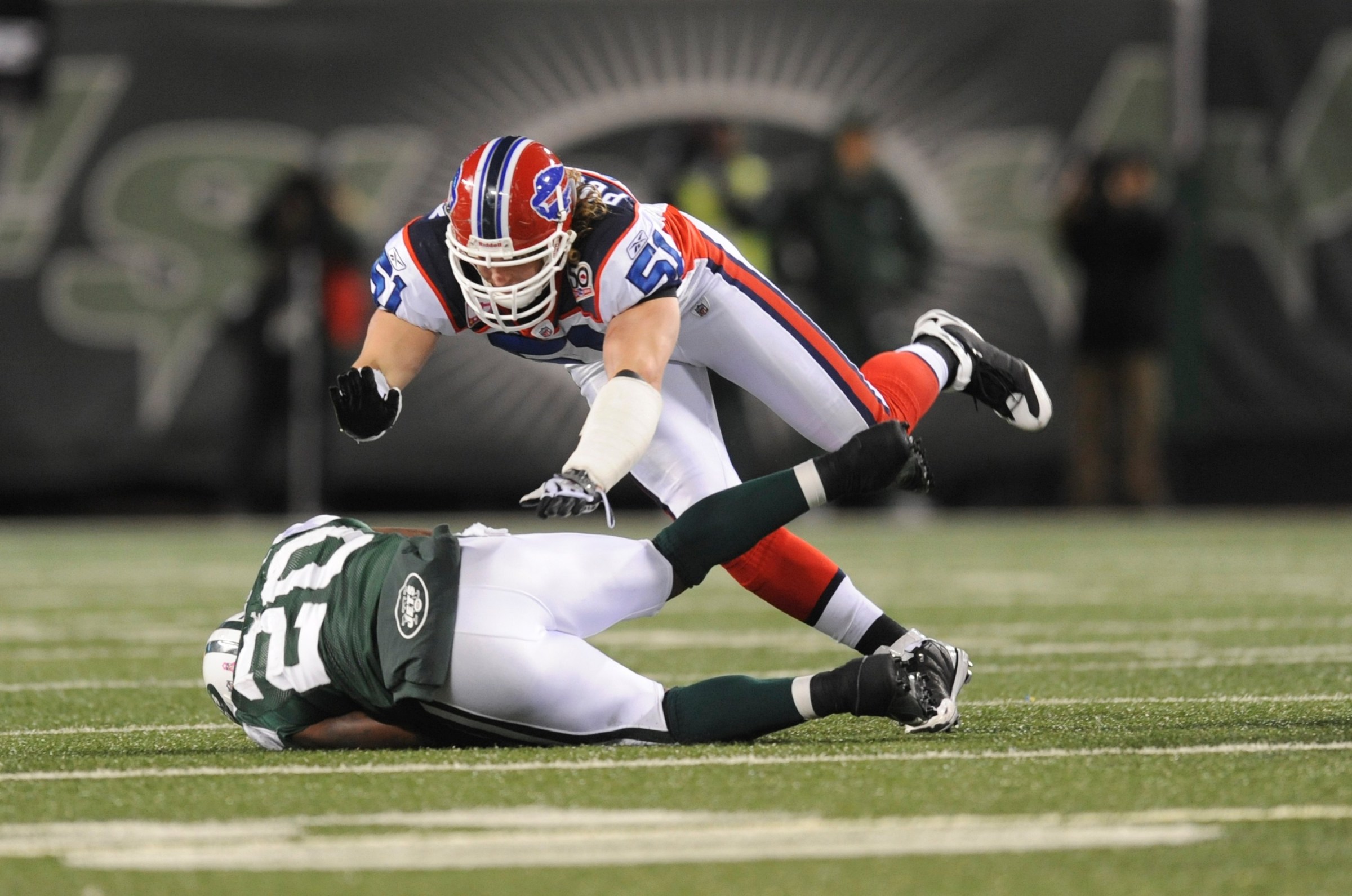 EAST RUTHERFORD, NJ - OCTOBER 18: Paul Posluszny #51 of the Buffalo Bills tackles Thomas Jones #20 of the New York Jets at Giants Stadium on October 18, 2009 in East Rutherford, New Jersey. The Bills defeated the Jets 16-13 in overtime. (Photo by Rob Tringali/Sportschrome/Getty Images)