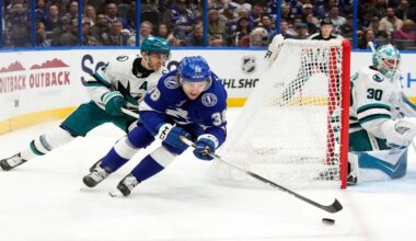 Tampa Bay Lightning left wing Brandon Hagel (38) beats San Jose Sharks center Alexander Wennberg (21) to the puck during the second period of an NHL hockey game Tuesday, Jan. 20, 2026, in Tampa, Fla. (AP Photo/Chris O'Meara)