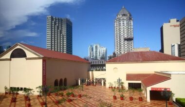 photo of a two-building museum with skyscrapers behind it