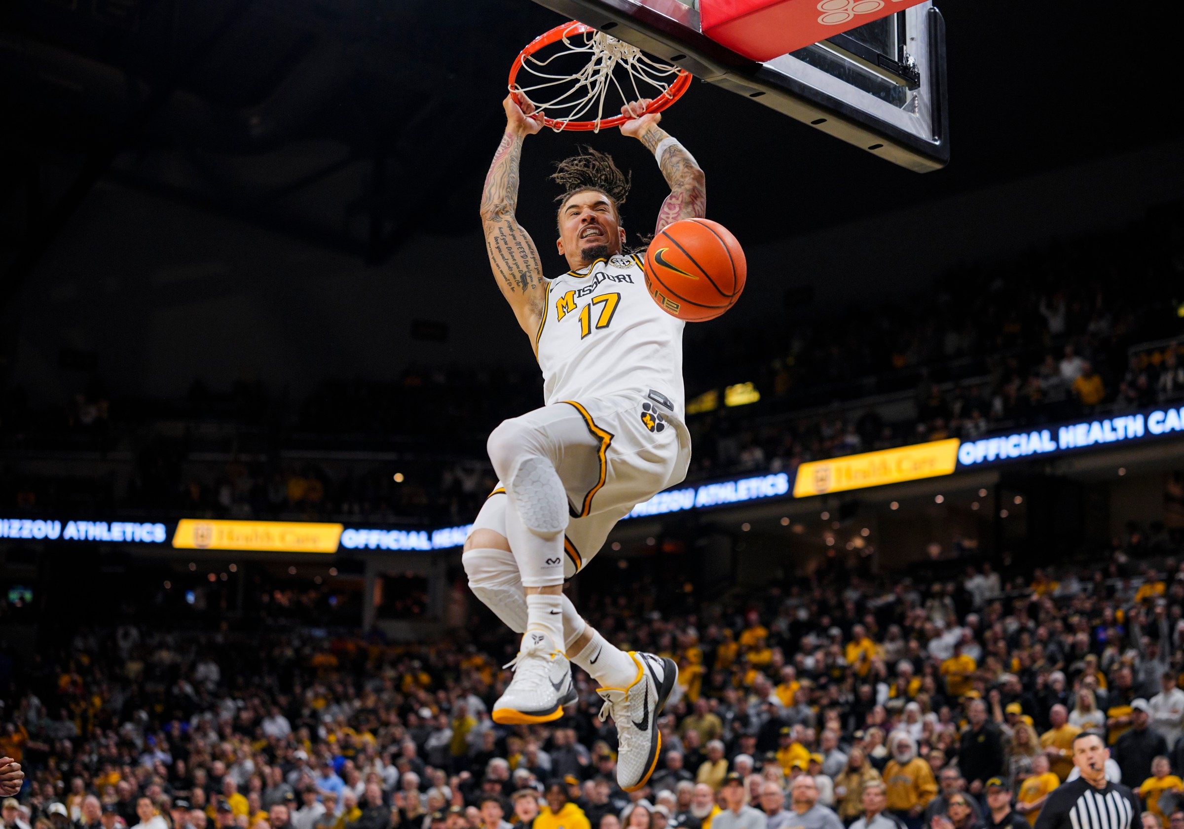 Jan 3, 2026; Columbia, Missouri, USA; Missouri Tigers guard Jayden Stone (17) dunks the ball during the first half against the Florida Gators at Mizzou Arena. Mandatory Credit: Jay Biggerstaff-Imagn Images