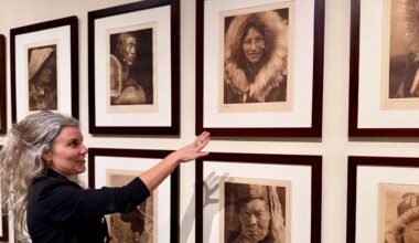 The James Museum's Associate Curator Caitlin Pendola is working to identify the unknown people in portrait work of Edward R. Curtis. Here she points out a woman with family in Florida. Photo By Virginia Johnson/Staff