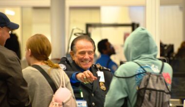 A TSA workers reaches for a traveler's identification at Orlando International Airport. (Spectrum News/Phil Petersen)