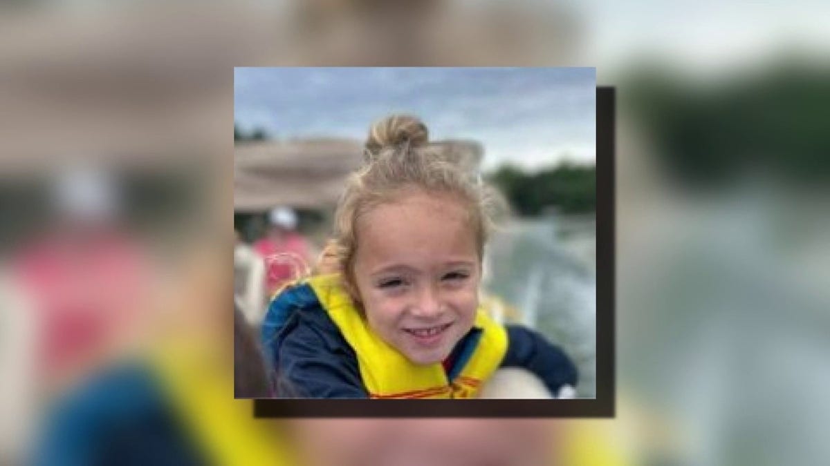 Johnathan Boley smiling in an undate photo, wearing a yellow life vest.