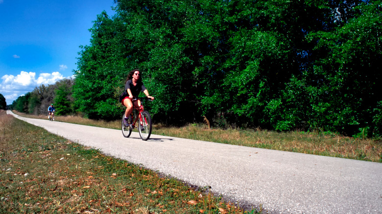 A person cycling along the Withlacoochee State Trail in Florida