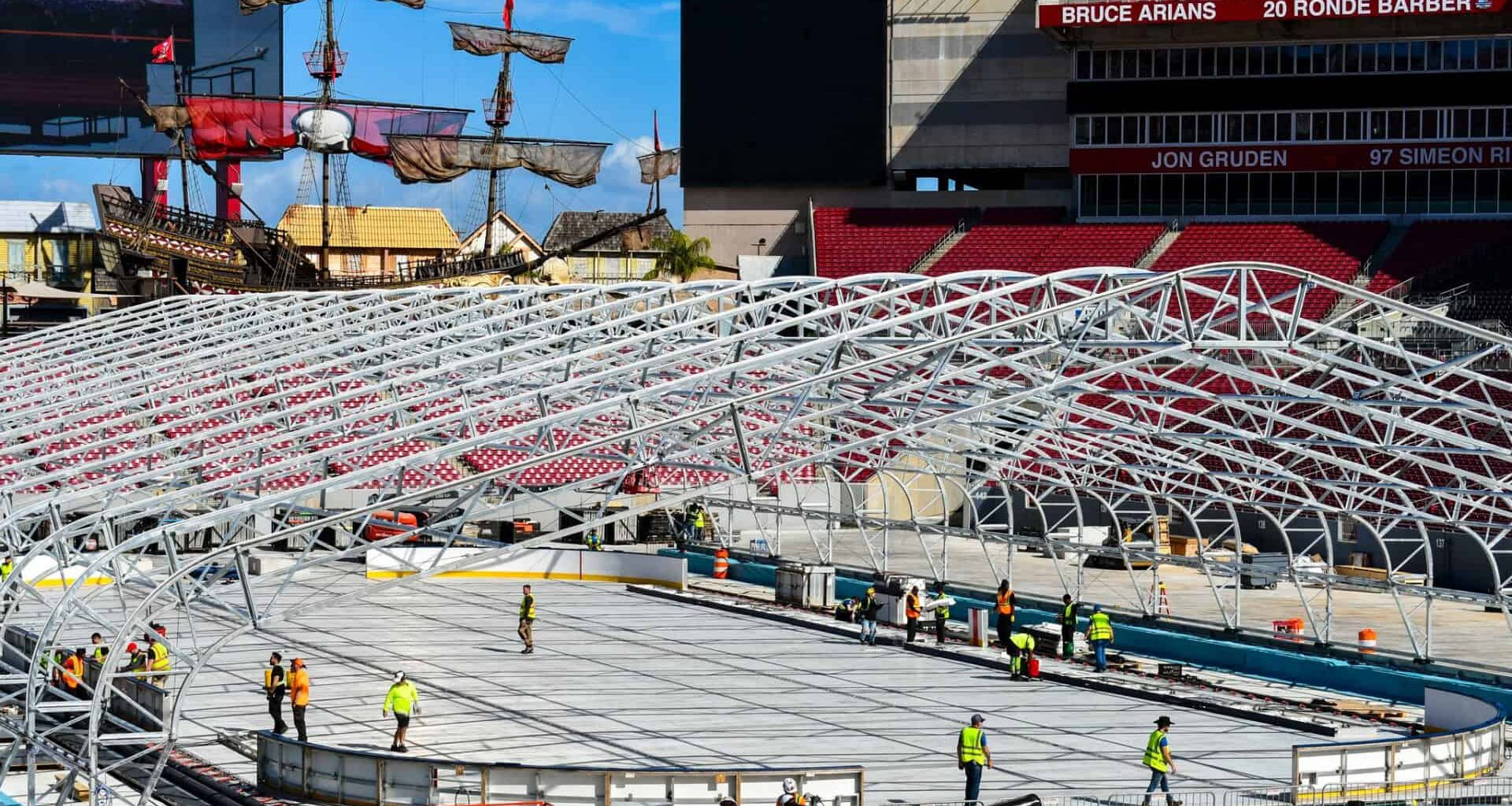 A hockey rink being constructed inside a football stadium
