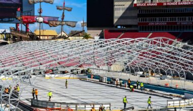 A hockey rink being constructed inside a football stadium