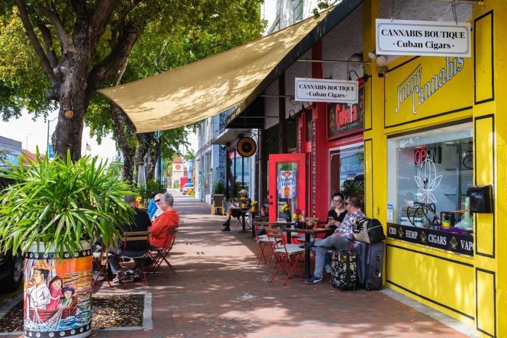 Cityscape scene along popular Calle Ocho in historic Little Havana with cigar shops and restaurants