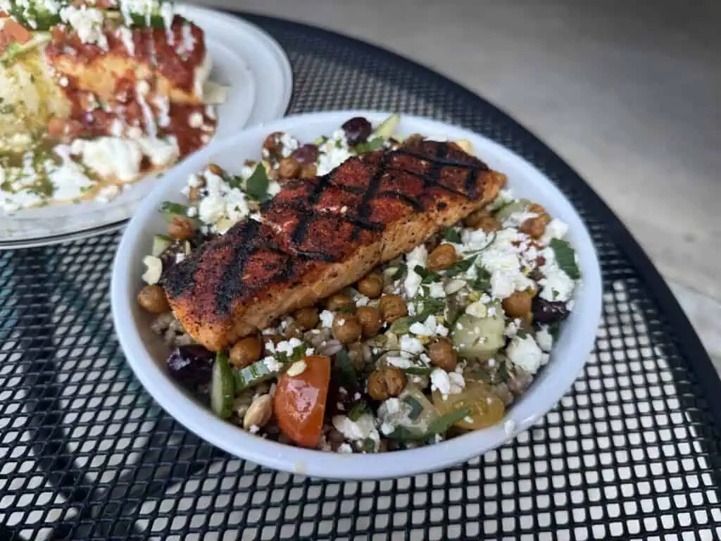 Plates of brunch food on an outdoor table