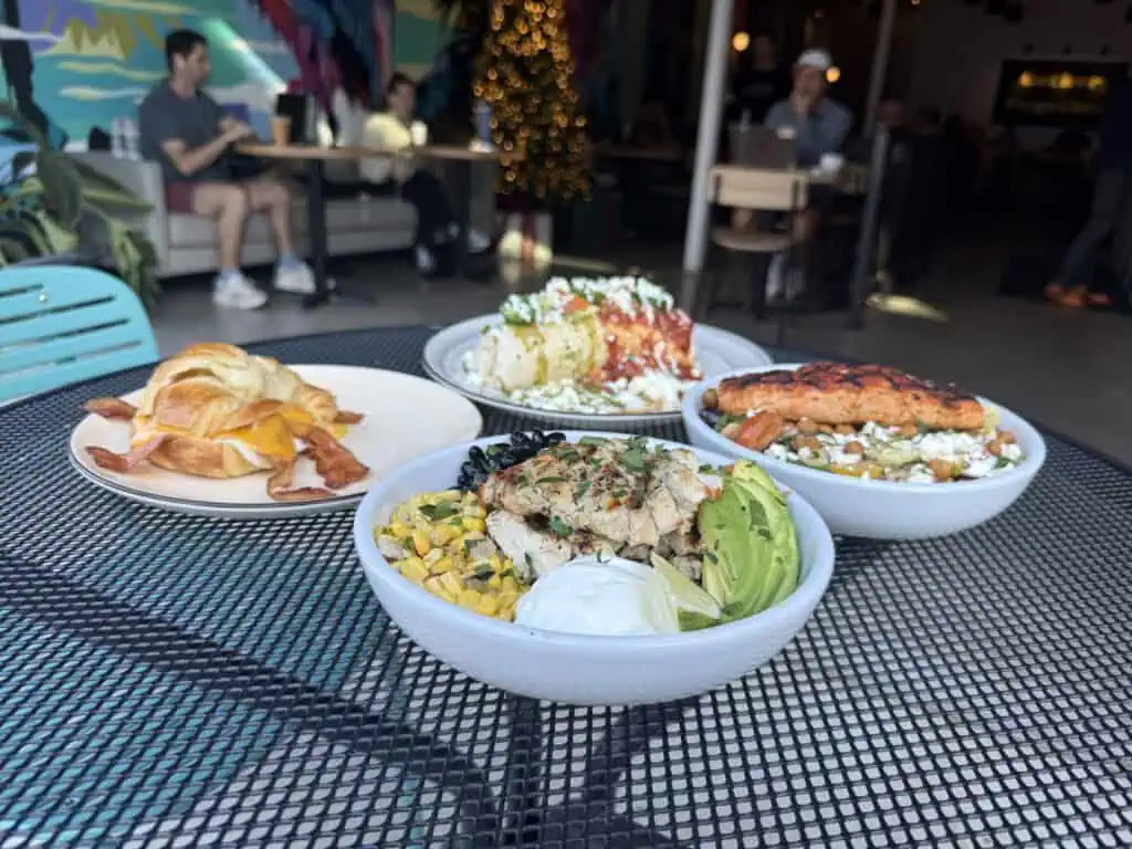 Plates of brunch food on an outdoor table