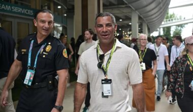 Miami Mayor Francis Suarez walking in the paddock with a city of Miami police officer at the 2025 Miami Grand Prix.