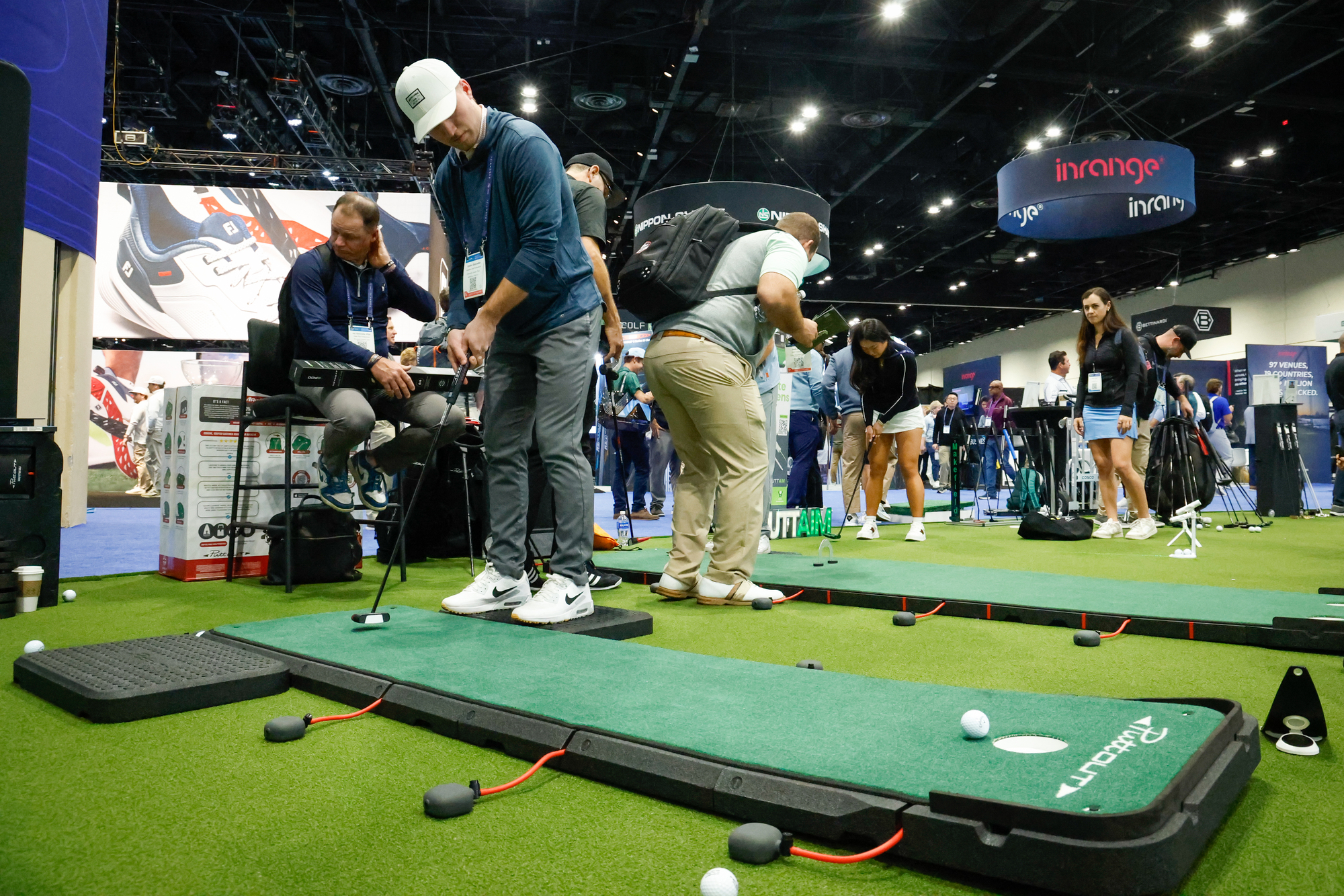 A PGA Show attendee tries out a Puttout AirBrake practice...