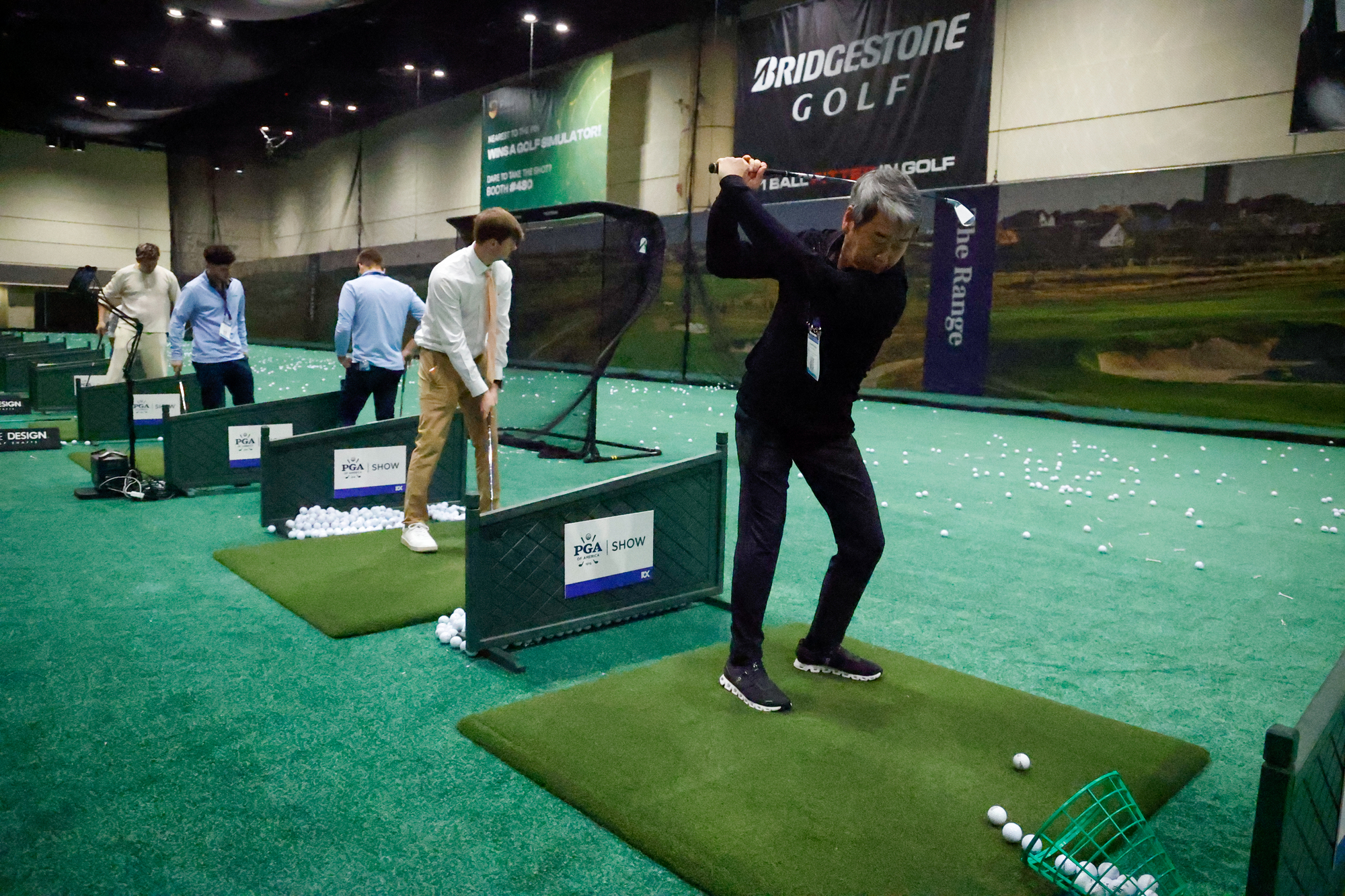 PGA Show attendee try out products at the demo range...