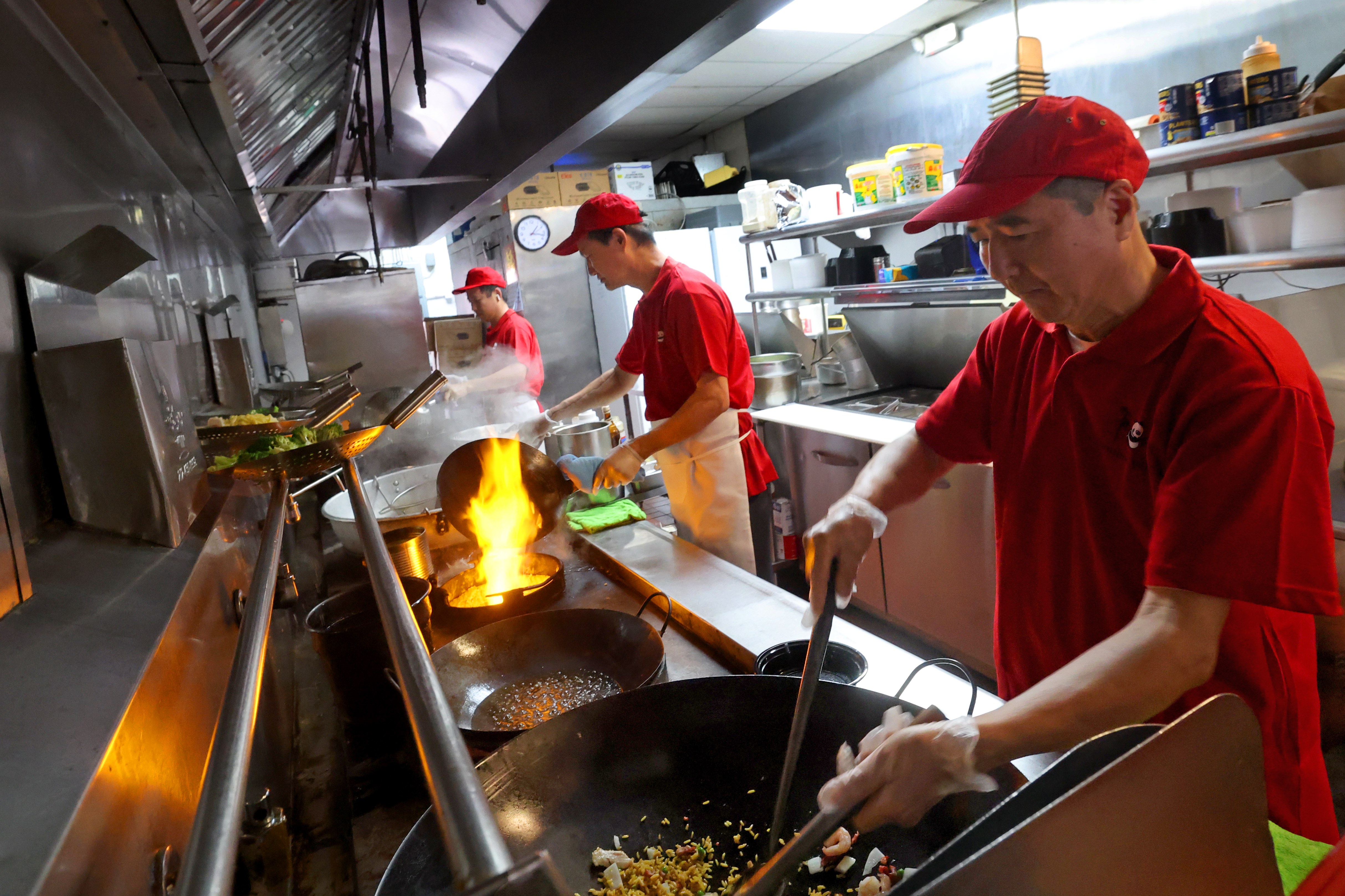 Louis, Lin and Ping Liu work the woks at Bamboo...