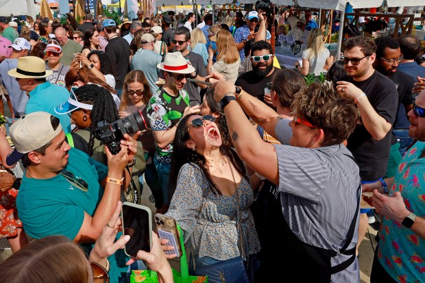 Lola Malyska gets truffles shaved iron her mouth by Executive Chef. TRP Taste/ Rooftop @1WLO during the Grand Tasting for Visit Lauderdale Food & Wine Festival at Las Olas Oceanside Park on Saturday Jan. 18, 2025. (Mike Stocker/South Florida Sun Sentinel)