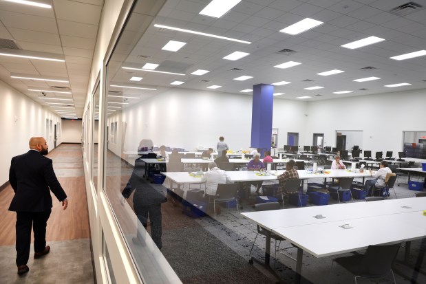 Broward County Supervisor of Elections Joe Scott walks past a viewing window at the state-of-the-art Supervisor of Elections headquarters in Fort Lauderdale. (Carline Jean/South Florida Sun Sentinel)