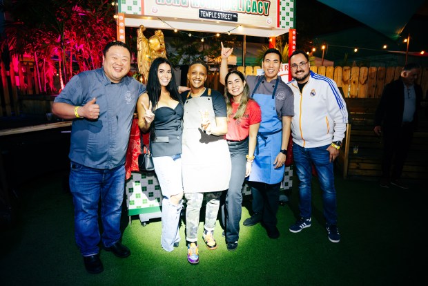 Chefs Alex Kuk, far left, and Diego Ng, second from right, are the organizers behind the Asian street food and music bash Wok 'n Roll, seen here at its 2025 event. Wok 'n Roll will move to Las Olas Intracoastal Promenade Park when it returns Jan. 22. (Coastal Click Photography for Visit Lauderdale Food and Wine Festival / Courtesy)