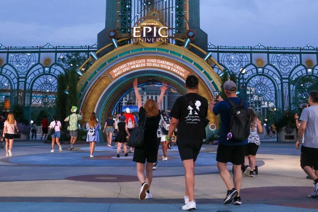 Excited guests at Universal's Epic Universe on May 22, 2025, quickly make their way to the main entrance portal shortly after the 6:30 a.m. grand opening of the park. (Rich Pope/Orlando Sentinel file)