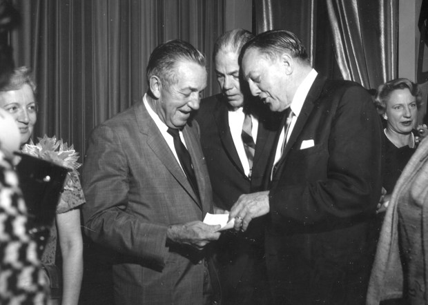 Walt Disney, left, talks with Gov. Haydon Burns, center, and Orlando Sentinel publisher Martin Andersen in the fall of 1965 at a reception to celebrate the announcement of Disney's Florida plans. The event took place at the now-gone Egyptian Room of the hotel on Lake Eola most often remembered as the Cherry Plaza. (Orlando Sentinel file)