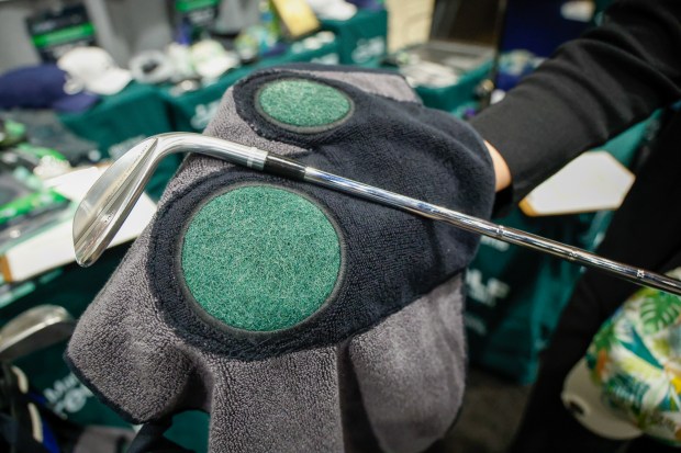 The Mark Yours Greens 3-in-1 Golf Towel on display at the PGA Show in Orlando Jan. 22 at the Orange County Convention Center. The multifunction towel is designed for scrubbing debris from clubs after use and features a built-in glove and magnetic clip. (Rich Pope, Orlando Sentinel)